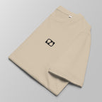 Close-up of a folded ecru padel t-shirt with a small black logo on the left chest.