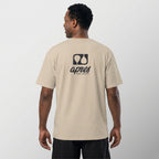 Male model with back toward camera wearing an oversized ecru unisex padel t-shirt in relaxed fit with a black logo central on the back.