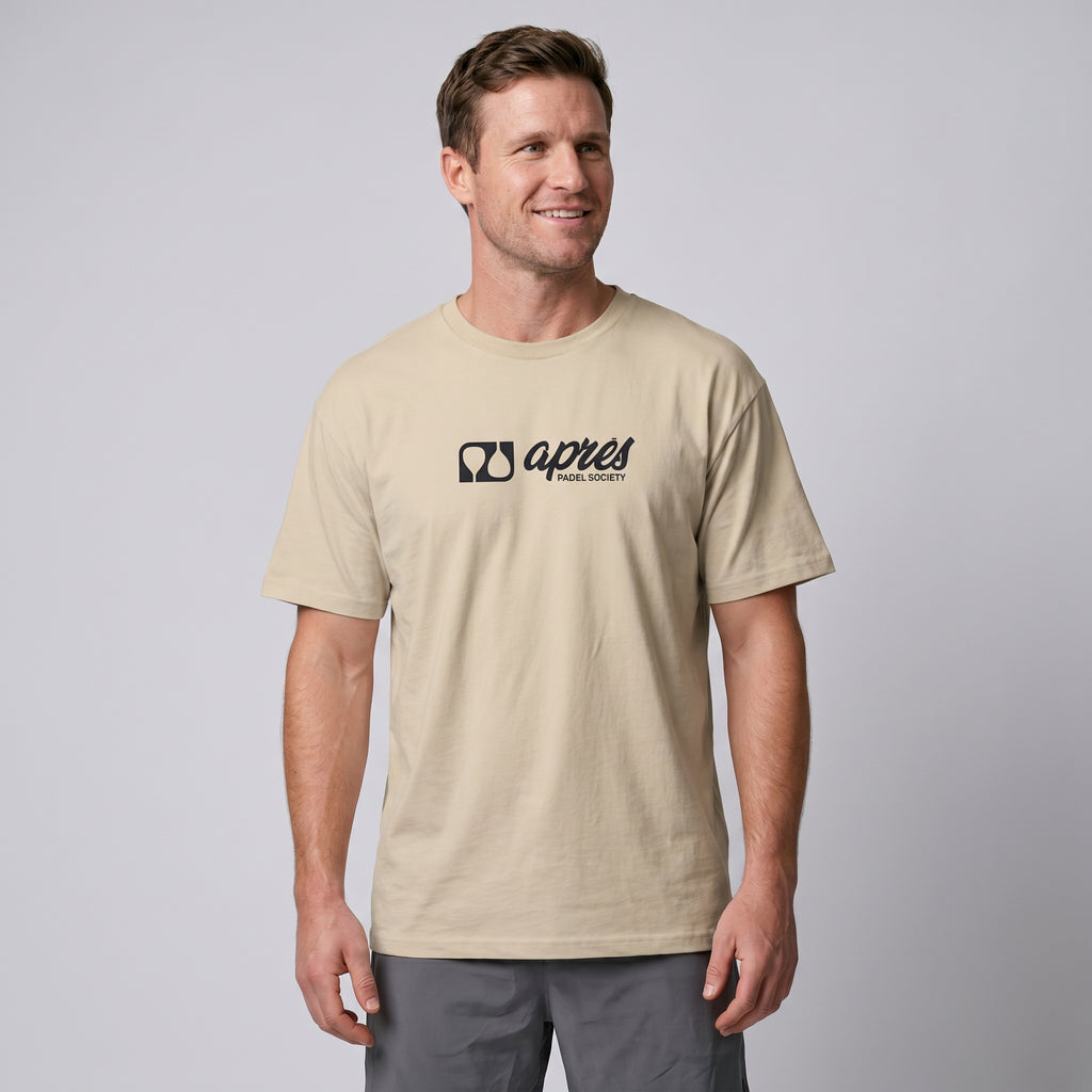 Male model wearing an oversized unisex ecru padel t-shirt in relaxed fit with a black horizontal chest logo.