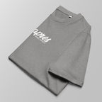 Close-up of a folded heather grey padel t-shirt with white 'Après Padel Society' logo centred.