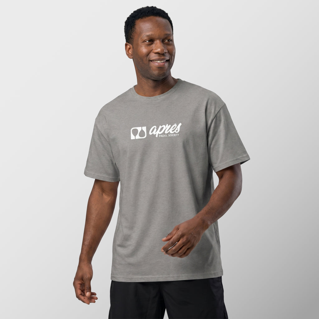 Male model wearing an oversized unisex heather grey padel t-shirt in relaxed fit with a white horizontal chest logo.