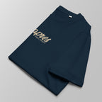Close-up of a folded navy blue padel t-shirt with the tan 'Après Padel Society' logo centred.