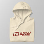 Close-up of a folded cream premium padel hoodie with the red 'Après Padel Society' logo centred.