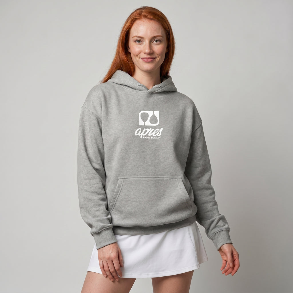 Woman modelling a heather grey premium padel hoodie with a white 'Après Padel Society' logo.