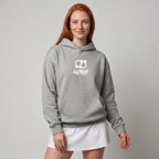 Woman modelling a heather grey premium padel hoodie with a white 'Après Padel Society' logo.
