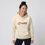 Woman modelling a cream premium padel hoodie with a red horizontal 'Après Padel Society' logo.